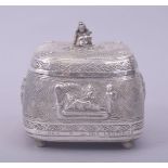 A FINE INDIAN SILVER PANDAN LIDDED BOX, the lid with baby Krishna finial, the box raised on four