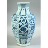 A CHINESE BLUE AND WHITE OCTAGONAL SHAPE VASE, painted with floral panels and with two moulded beast