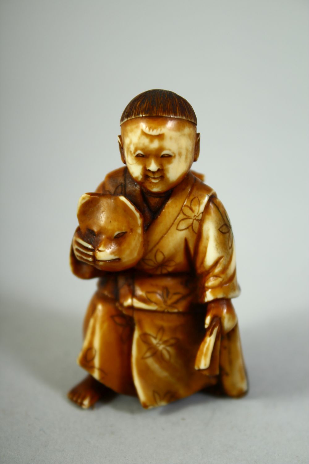 TWO CARVED NETSUKES, one of a boy holding a noh mask, the other of a sage, (2). - Image 5 of 7