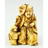 A JAPANESE CARVED IVORY NETSUKE, of a noh actor with a child by his side, 4.5cm high.