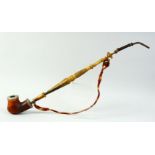 A 19TH CENTURY MEERSCHAUM PIPE with silver mounts and long turned horn handle.