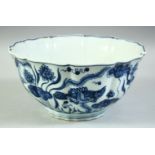 A CHINESE BLUE AND WHITE PETAL SHAPED PORCELAIN BOWL, decorated with fish, lotus and algae, the base