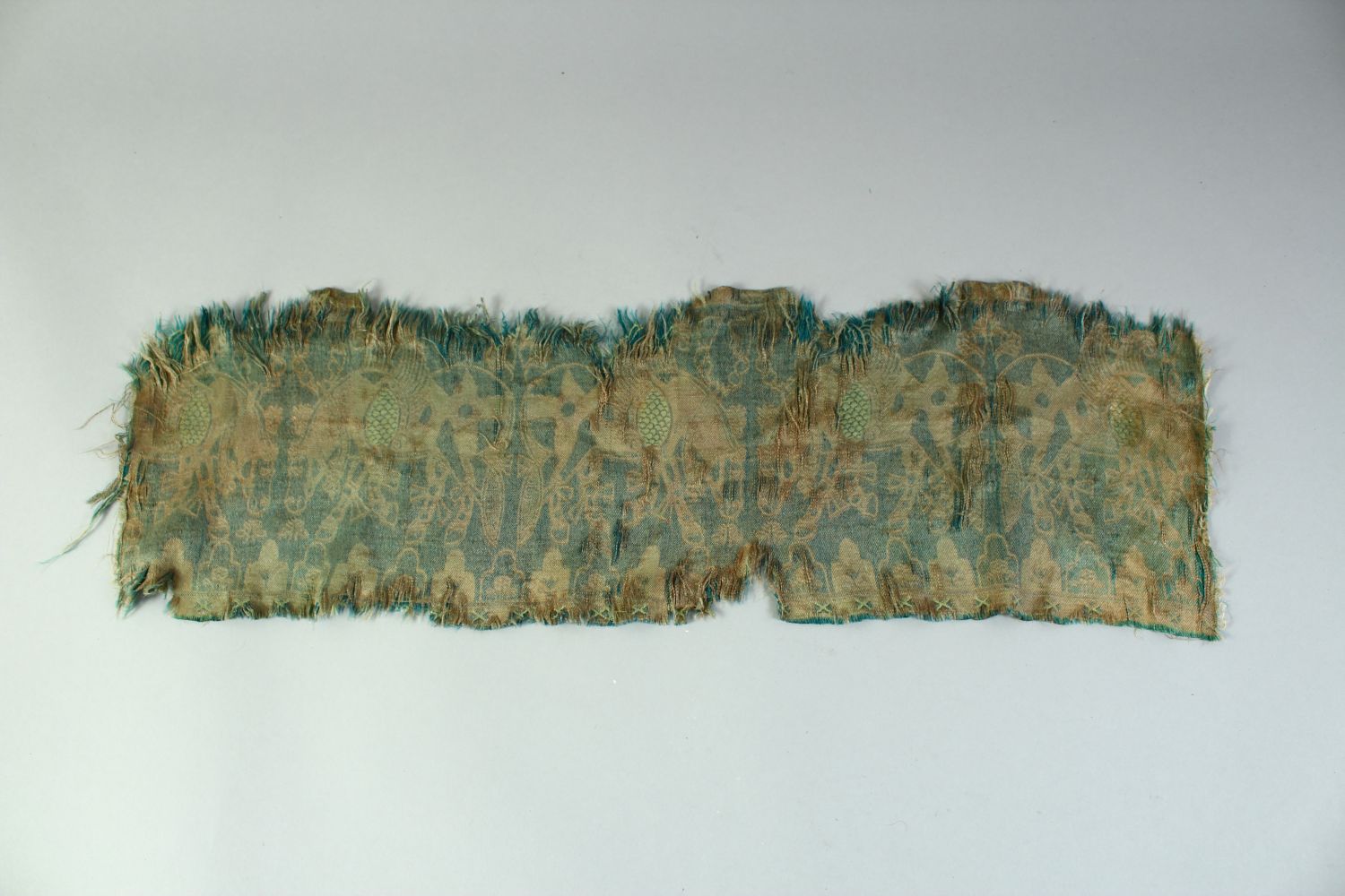 AN ISLAMIC TEXTILE FRAGMENT, embroidered with horses. - Image 5 of 8