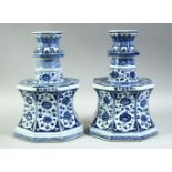 A RARE PAIR OF CHINESE BLUE AND WHITE OCTAGONAL PORCELAIN CANDLE HOLDERS, each profusely painted