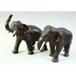 A SUPERB PAIR OF JAPANESE BRONZE ELEPHANTS, with carved ivory tusks, each with impressed seal mark