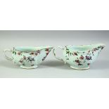 A NEAR PAIR OF 18TH CENTURY CHINESE FAMILLE ROSE PORCELAIN SAUCE BOATS, 19cm and 18.5cm long.