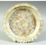 AN INDIAN GOA MOTHER OF PEARL DISH, made entirely of cut pieces of mother of pearl, 19cm diameter.