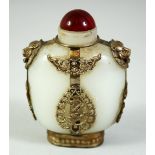 A CHINESE SILVER-METAL OVERLAID WHITE JADE-LIKE GLASS SNUFF BOTTLE & STOPPER, 3.5in high.