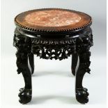 A CHINESE CARVED HARDWOOD AND MARBLE INSET STAND, with pierced frieze and supported on four carved