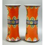 A RARE PAIR OF CHINESE ORANGE GROUND PORCELAIN GU VASES, decorated with various motifs, each with