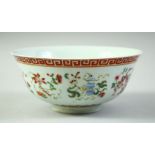 A CHINESE FAMILLE ROSE PORCELAIN BOWL, decorated with symbolic emblems and with greek key band to