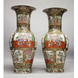 A VERY LARGE PAIR OF CHINESE CANTON FAMILLE ROSE PORCELAIN FLOOR STANDING VASES, decorated with