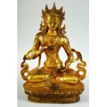 A GILT BRONZE MODEL OF A SEATED DEITY, 27cm high.