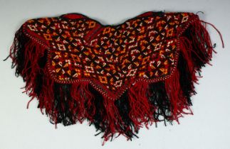A TURKAMAN BABY PONCHO, all over embroidered design with fringed edge, approx. 37cm diameter.