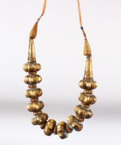AN ISLAMIC GILDED SOFT METAL NECKLACE.