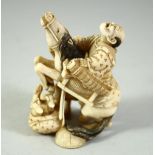 A JAPANESE CARVED IVORY OKIMONO, of a figure on a bucking horse, with another figure at his side,