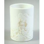 A SMALL CHINESE BLANC DE CHINE BRUSH POT, with raised decoration, the base with four character mark,