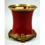 A CHINESE SANG DE BOUEF PORCELAIN BRUSH POT, with ormolu mounts, 18cm high.