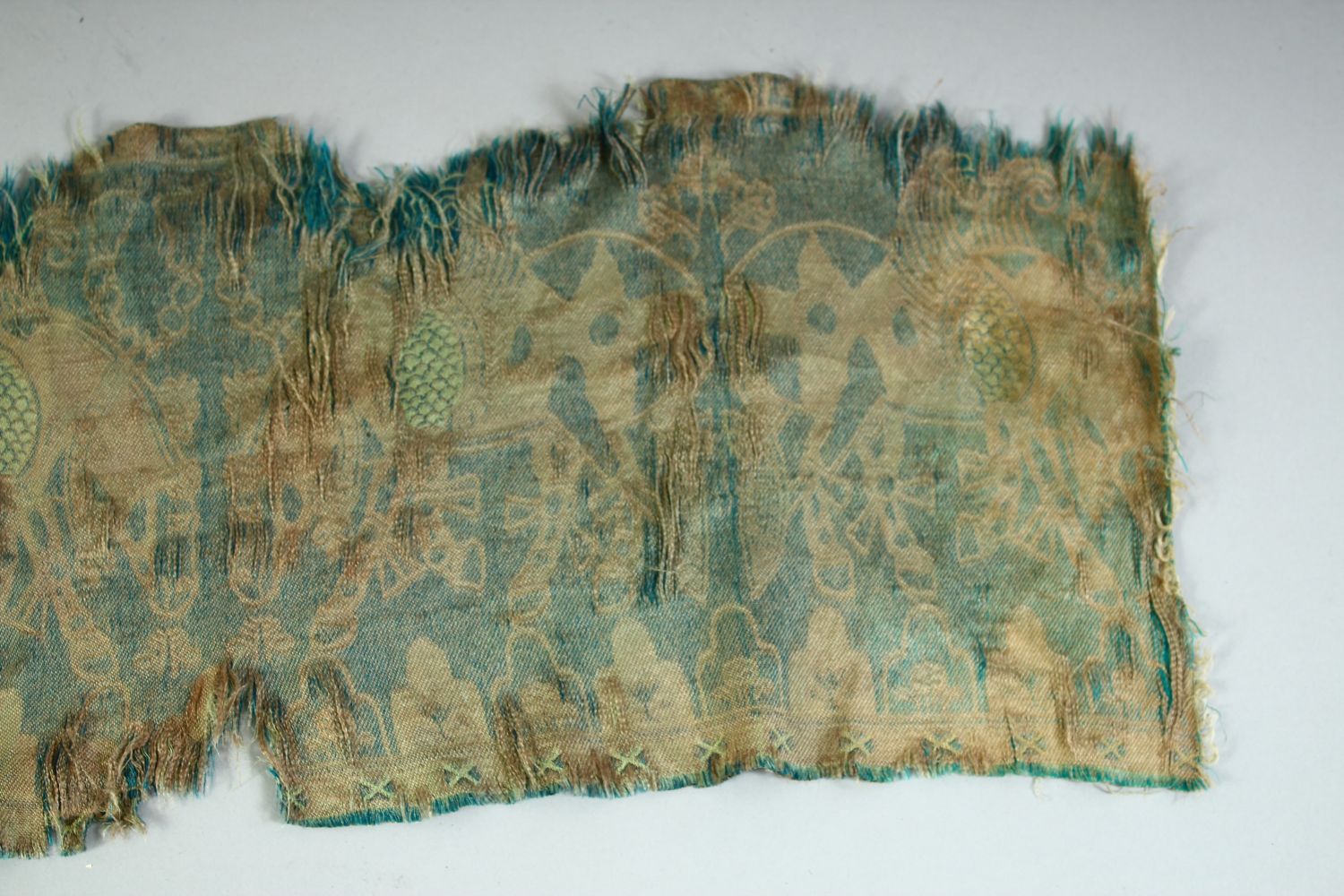 AN ISLAMIC TEXTILE FRAGMENT, embroidered with horses. - Image 6 of 8