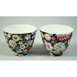 A PAIR OF CHINESE QING POLYCHROME PORCELAIN TEA CUPS, decorated with flowers, six character mark