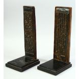 A PAIR OF CARVED WOOD CALLIGRAPHIC TABLETS, on stands.