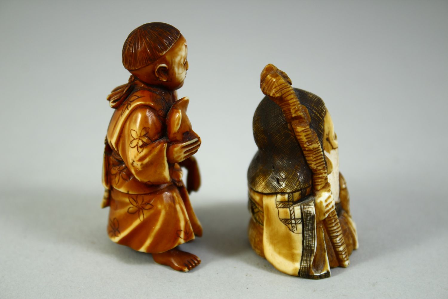 TWO CARVED NETSUKES, one of a boy holding a noh mask, the other of a sage, (2). - Image 2 of 7