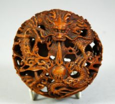 A SUPERB CHINESE PIERCED BOXWOOD CARVING, with intertwining dragons amongst clouds and bearing the
