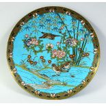 A CHINESE CLOISONNE CHARGER, decorated with birds amongst foliage. 12ins diameter.