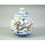 A CHINESE POLYCHROME TEA JAR AND COVER, decorated with dragons and clouds, 11.5cm high.
