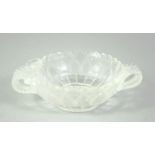 A SMALL INDIAN CUT GLASS PETAL FORM BOWL, with leaf formed twin handles, 11cm wide from handle to