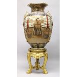 A HIGHLY IMPRESSIVE AND MONUMENTAL JAPANESE SATSUMA FLOOR STANDING VASE on a carved gilt wood stand,