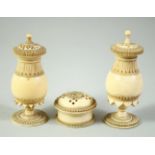 A GOOD NEAR PAIR OF INDIAN TURNED IVORY PEDESTAL POUNCE POTS, 8cm high, and a similar pot and cover,