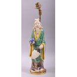 A CHINESE GREEN AND YELLOW PARTLY GLAZED POTTERY FIGURE mounted as a lamp, overall height 42cm