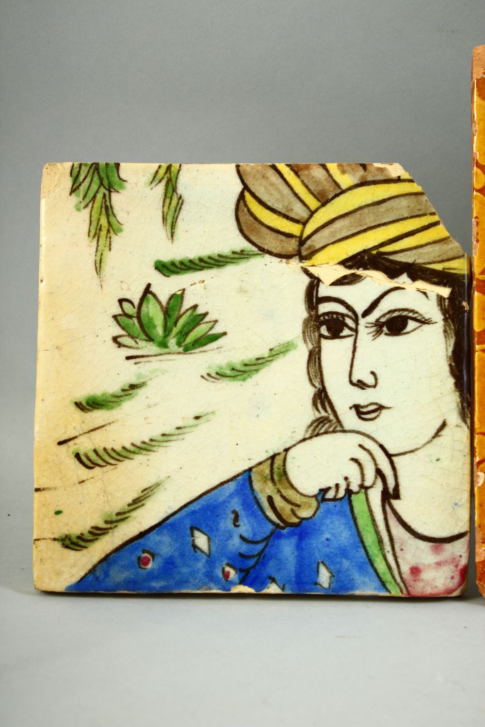 FOUR ISLAMIC GLAZED POTTERY TILES, three with foliate decoration and one with a section of a figure, - Image 3 of 5