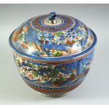 A LARGE JAPANESE ARITA PORCELAIN CLOBBERED BOWL AND COVER, painted with a landscape scene with