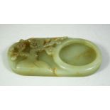 A CHINESE CARVED JADE INK STONE, 11cm x 6cm.