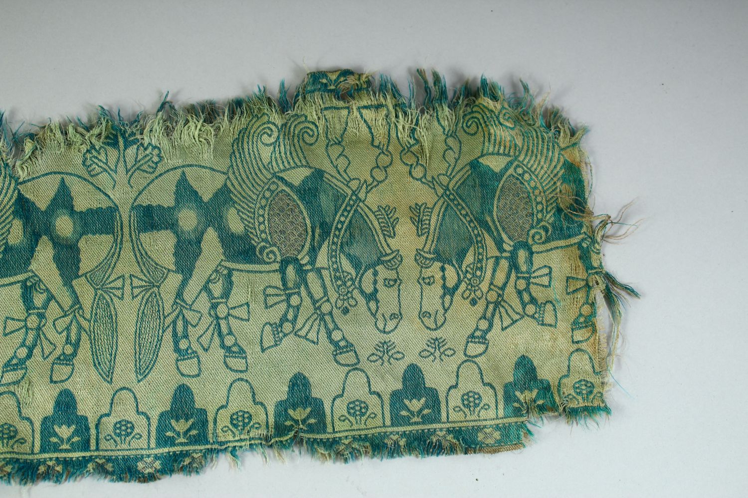 AN ISLAMIC TEXTILE FRAGMENT, embroidered with horses. - Image 4 of 8