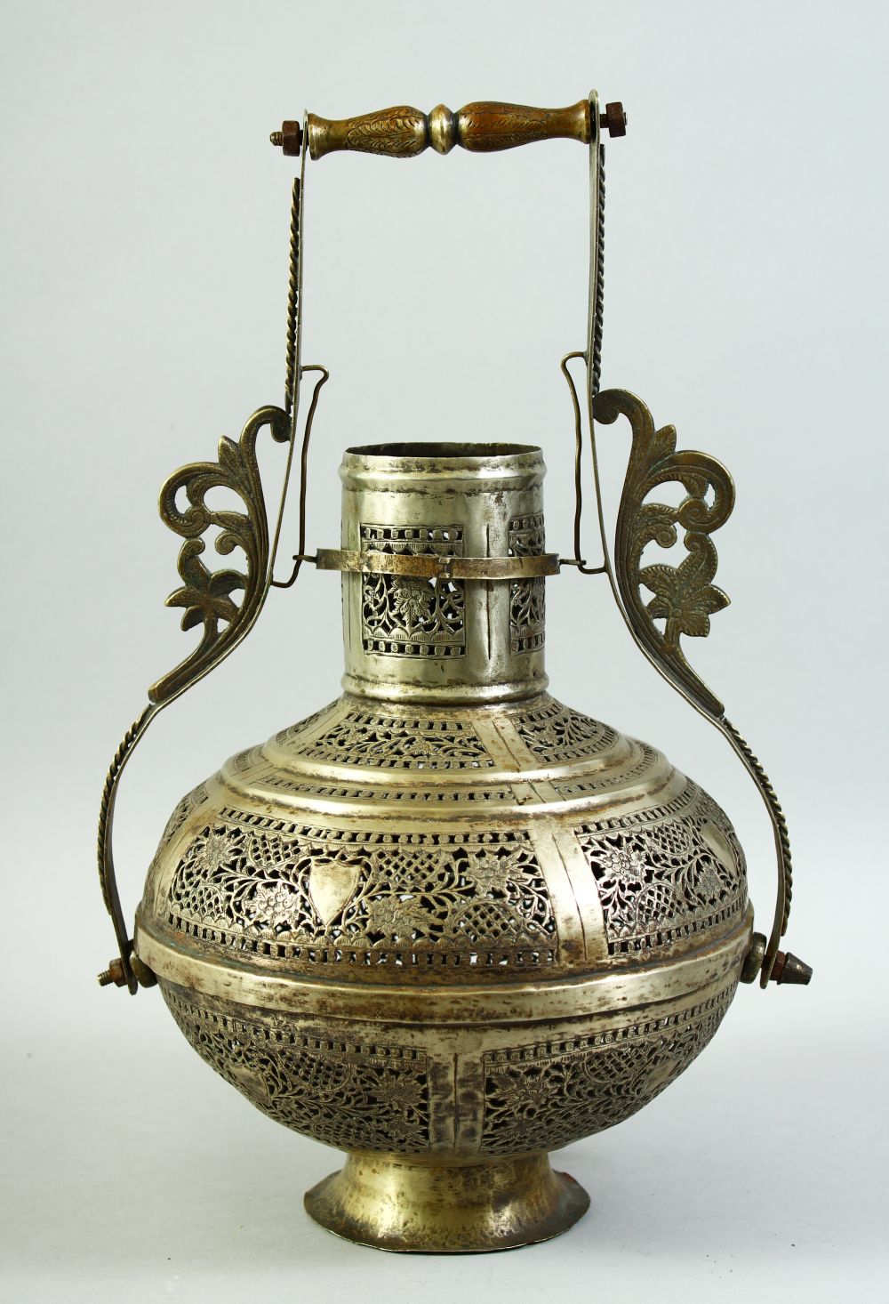 AN ISLAMIC OPENWORK METAL LANTERN / LAMP, with pierced floral decoration and handle, 38cm high