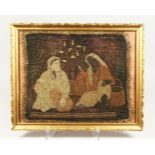 A TURKISH OTTOMAN TEXTILE, depicting two figures, framed and glazed, 46cm x 57cm.