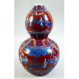 A CHINESE IRON RED AND BLUE DOUBLE GOURD PORCELAIN VASE, decorated with various figures in an
