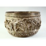 A LARGE BURMESE EMBOSSED AND CHASED SILVER BOWL, with raised decoration of figural scenes and