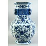 A LARGE CHINESE BLUE AND WHITE PORCELAIN TWIN HANDLE VASE, the body decorated with various flower