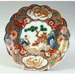 A JAPANESE IMARI PORCELAIN PETAL SHAPE DISH, painted with a bird and native flora with gilt