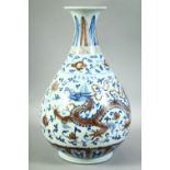 A CHINESE BLUE, WHITE AND UNDER-GLAZED RED YUHUCHUNPIN VASE, decorated with dragon and phoenix