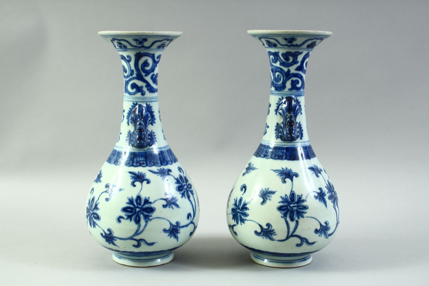 A PAIR OF CHINESE BLUE AND WHITE PORCELAIN VASES, with formed handles and floral decoration, 27. - Image 2 of 6