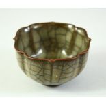 A CHINESE CRACKLE GLAZE PETAL FORM TEA CUP, 8cm diameter.