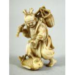 A SMALL JAPANESE CARVED IVORY FIGURE of a fisherman, with a large fish at his feet, the base inset