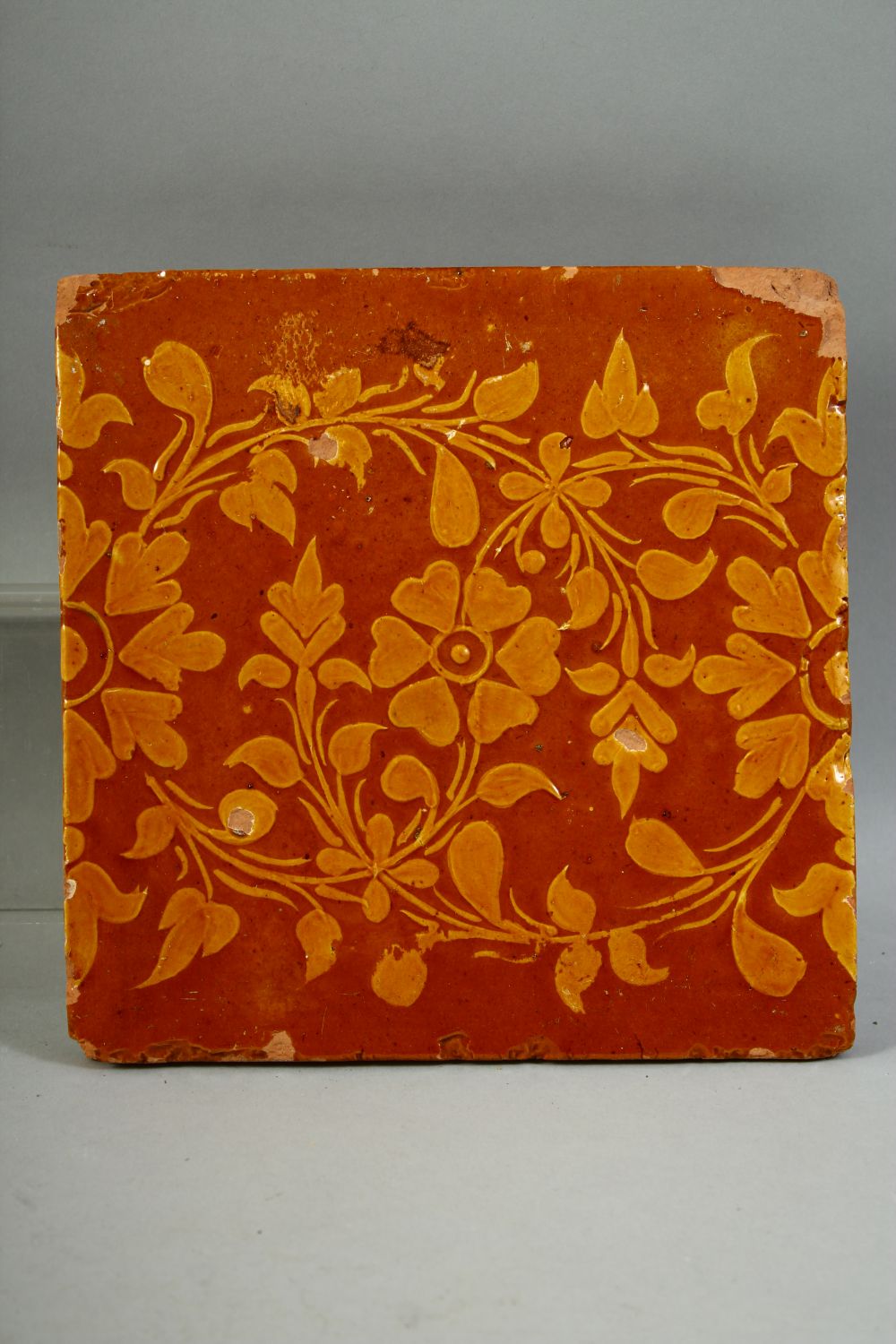 FOUR ISLAMIC GLAZED POTTERY TILES, three with foliate decoration and one with a section of a figure, - Image 4 of 5