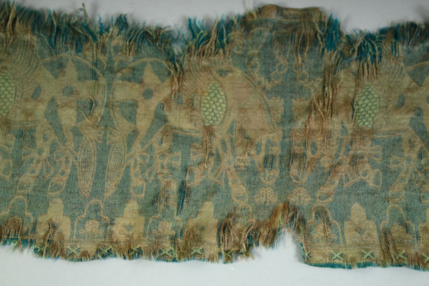 AN ISLAMIC TEXTILE FRAGMENT, embroidered with horses. - Image 7 of 8