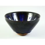 A CHINESE DARK BLUE GLAZE POTTERY BOWL, with carved mark to base, 12cm diameter.